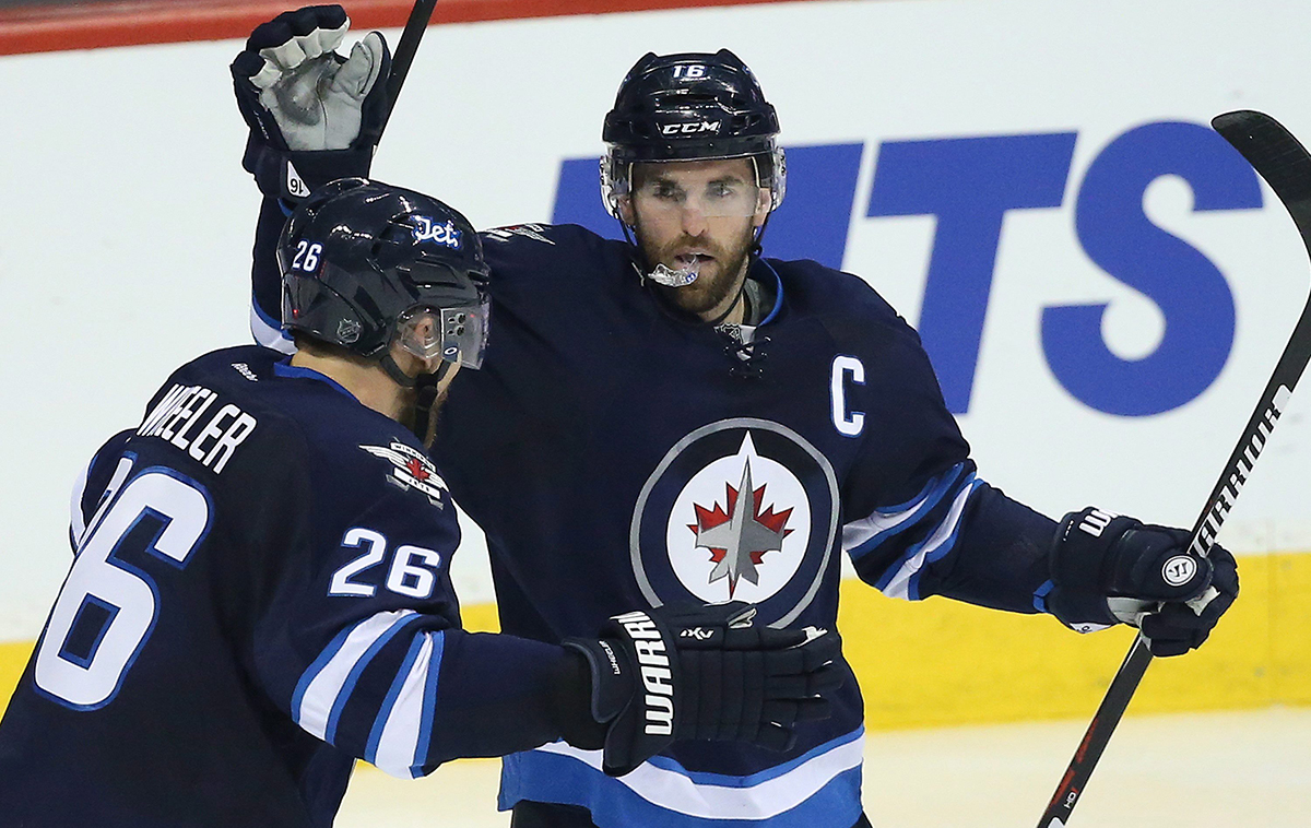 Winnipeg Jets' Andrew Ladd (16) and Blake Wheeler (26) celebrate Ladd's goal against the Toronto Maple Leafs.