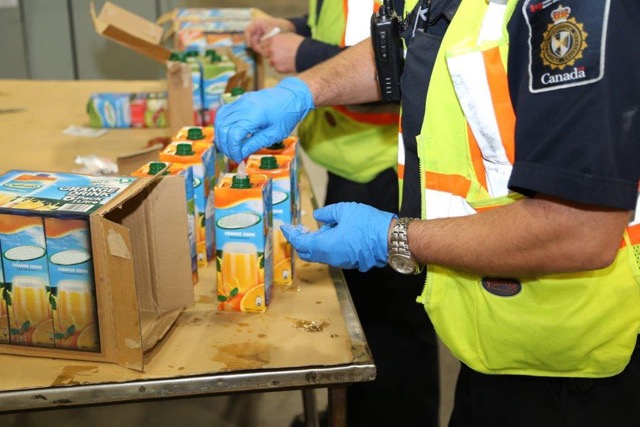 Juice boxes are tested for illegal substances in the Port of Halifax on Nov. 16.