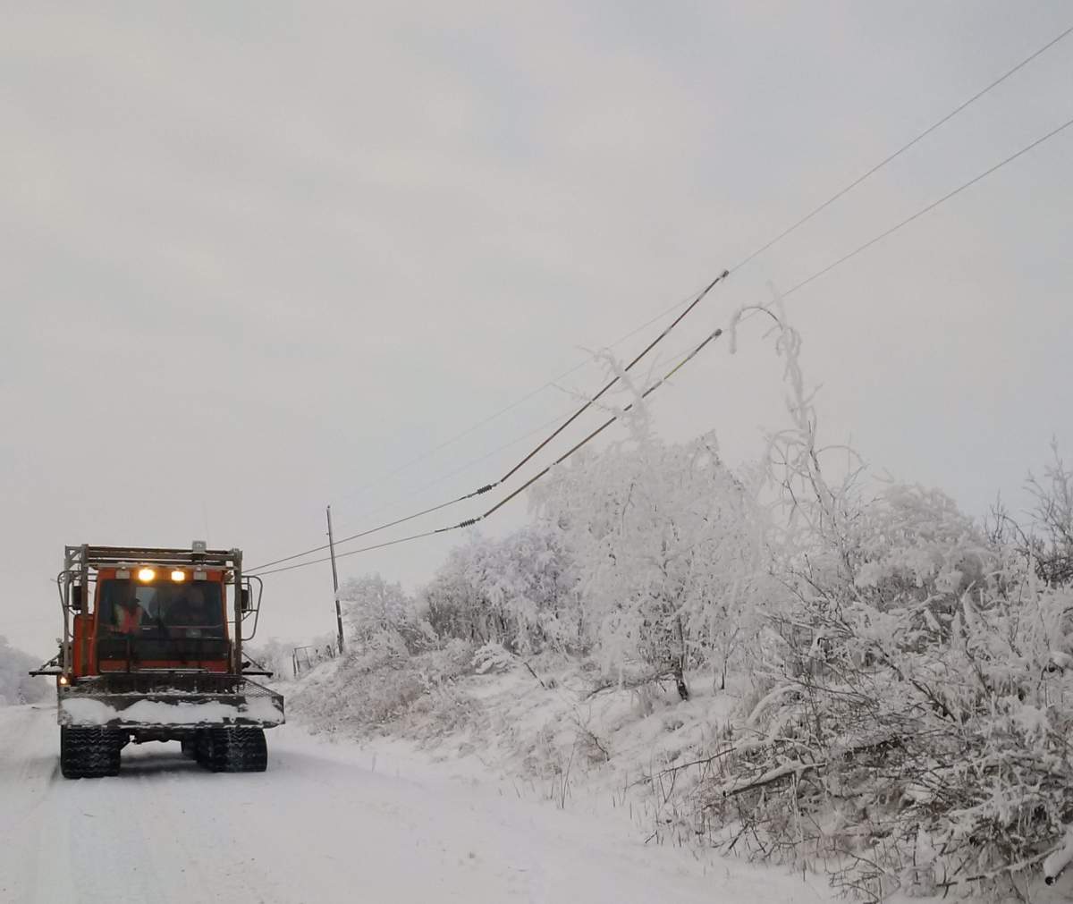 Manitoba Hydro crews Ice roll from a flex trak near Minnedosa Tuesday.
