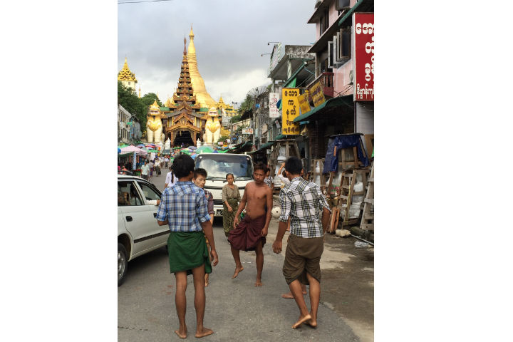 Teenagers play the traditional sport of Chinlone in front of an entrance to the Schwedagon Pagoda in Yangon.