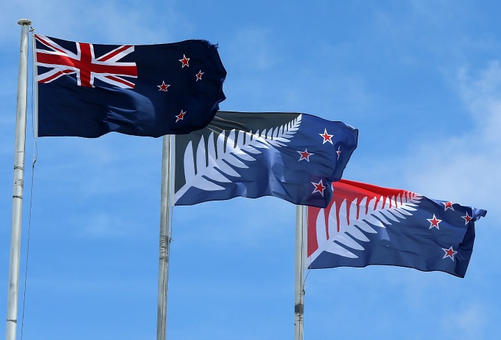 The current New Zealand flag (L) the referendum winning blue and black Kyle Lockwood designed flag (C) and the second placed red and blue flag (R) fly on a building in New Lynn, Auckland on December 14, 2015 in Auckland, New Zealand. New Zealanders voted on December 12 for a possible replacement to their current flag. 