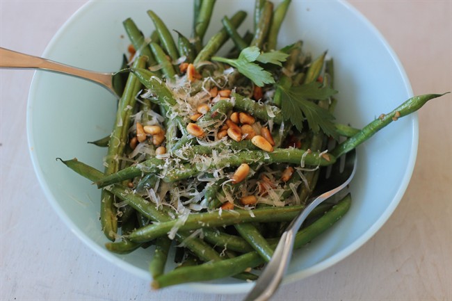 This Nov. 9, 2015, photo, shows green beans with anchovies, Parmesan and pine nuts in Concord, N.H. This recipe is by Melissa D'Arabian.