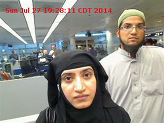 In this July 27, 2014, file photo, provided by U.S. Customs and Border Protection shows Tashfeen Malik, left, and Syed Farook, as they passed through O'Hare International Airport in Chicago.