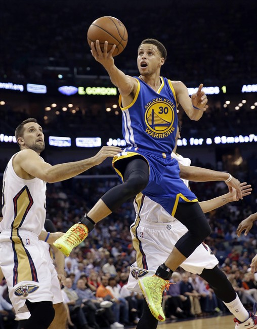 FILE - In this April 7, 2015, file photo, Golden State Warriors guard Stephen Curry (30) drives to the basket in front of New Orleans Pelicans forward Ryan Anderson in the first half of an NBA basketball game in New Orleans. Curry has been named The Associated Press 2015 Male Athlete of the Year. 