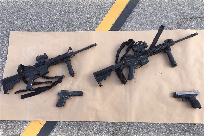 This photo provided by the San Bernardino County Sheriff's Department shows weapons carried by suspects at the scene of a shootout in San Bernardino, Calif. 