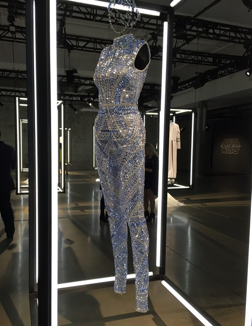 An outfit inspired by the film, "Star Wars: The Force Awakens," is displayed at a gallery on Wednesday, Dec. 2, 2015, in New York. Fashion designers created outfits that pays homage to characters from the film as part of the "Force 4 Fashion," initiative. The outfits will be auctioned off with proceeds going to the Child Mind Institute.
