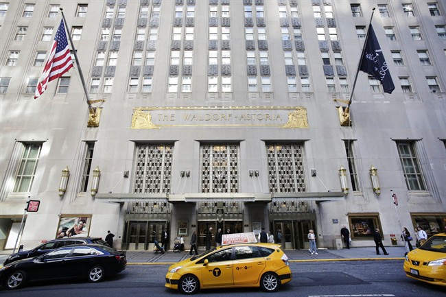 A taxi passes in front of the fabled Waldorf Astoria hotel in New York.