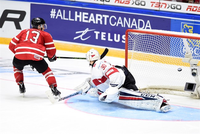 Canada's Mathew Barzal puts the game-winning shot past Switzerland's Joren van Pottelberghe during a shootout in preliminary round hockey action at the IIHF World Junior Championship in Helsinki, Finland on Tuesday, December 29, 2015.
