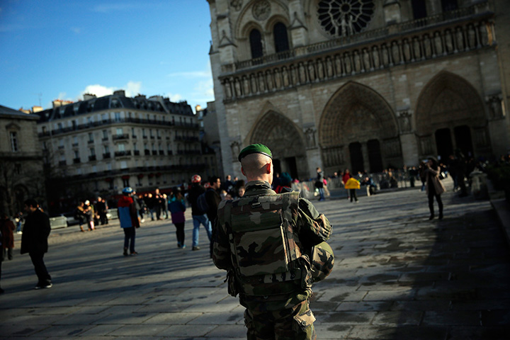 A soldier patrols in front of Notre Dame Cathedral, in Paris, Wednesday, Dec. 23, 2015. 