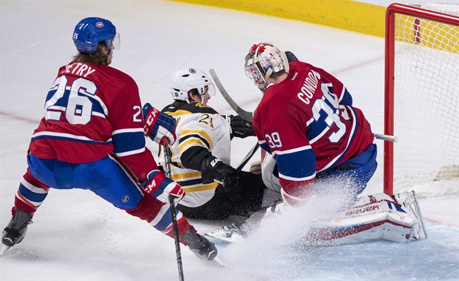 Boston Bruins' Loui Eriksson (21) slides away from Montreal Canadiens' defenceman Jeff Petry (26) after scoring a short-handed goal past goalie Mike Condon during third period NHL hockey action, in Montreal, on Wednesday, Dec. 9, 2015.