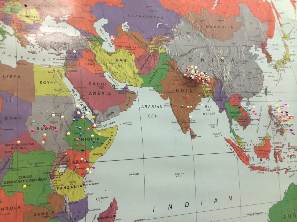 A world map, hanging in a classroom in St. Catherine School in Edmonton. Students have placed pins in the areas they lived before moving to Canada.