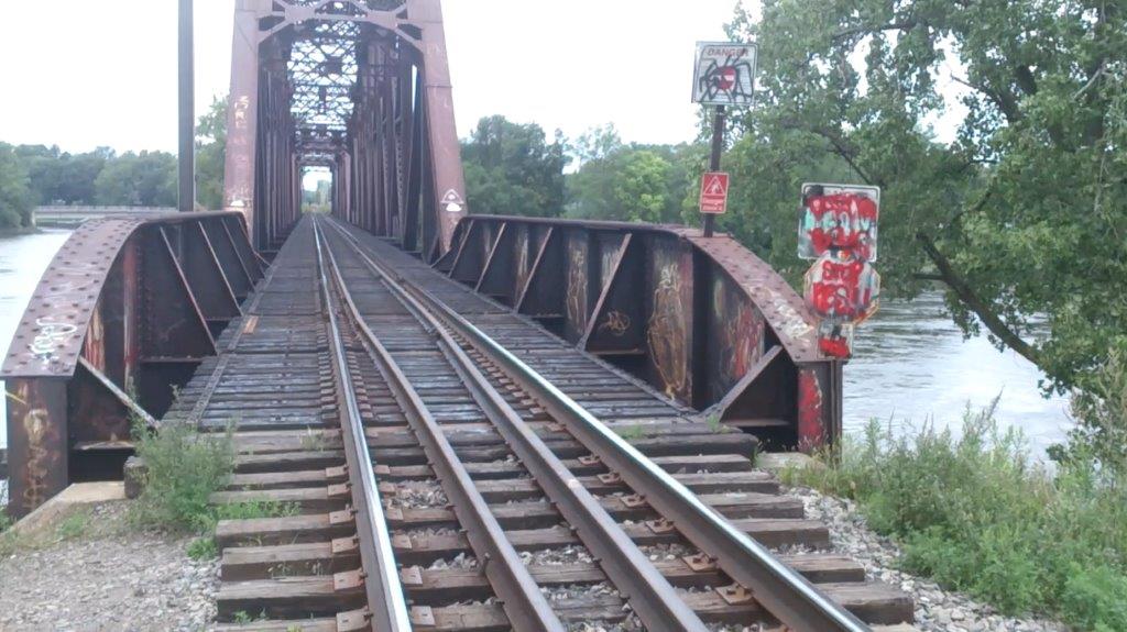 A photo taken in August 2015, shows the bridge where Kevin Bolusi was injured. The warning signs are covered in graffiti. Photo courtesy of the Bolusi family.