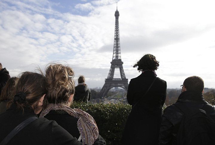 People observe a minute of silence at the Place de Trocadero in Paris on November 16, 2015 to pay tribute to victims of the attacks claimed by Islamic State which killed at least 129 people and left more than 350 injured on November 13.     