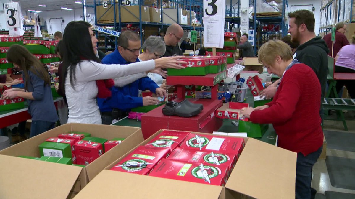 Volunteers pack shoeboxes at Operation Christmas Child processing centre in Calgary..