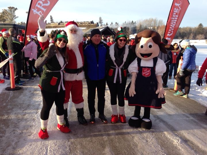 Founder and CEO of the Running Room John Stanton (C) takes part in the 25th annual Santa Shuffle in Edmonton Saturday, Dec. 5, 2015.