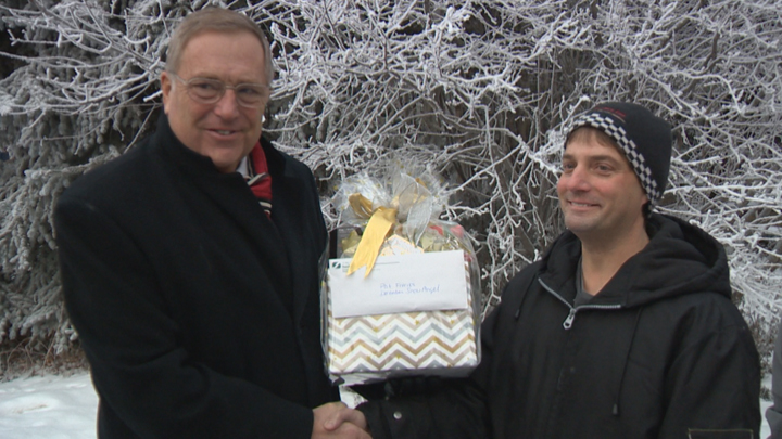Mayor Don Atchison congratulates Pat Freriks (right), the city’s first winner of the 2015-16 snow angel program.