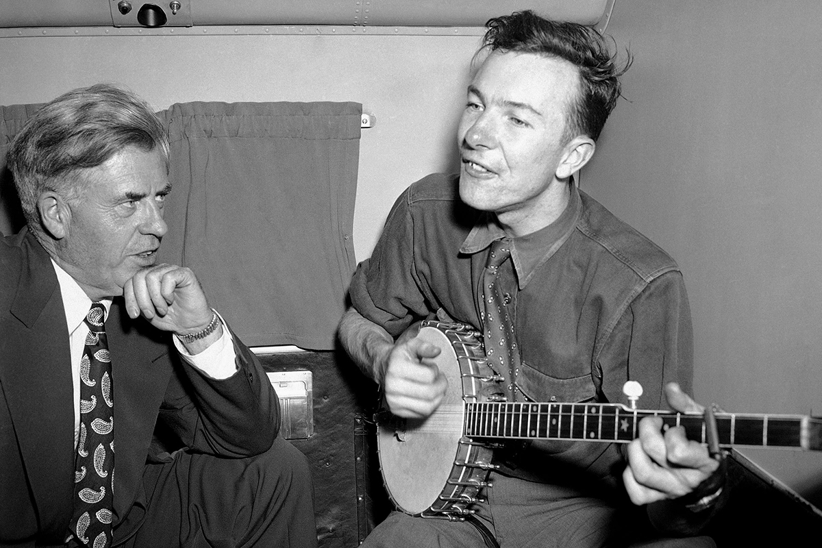In this Aug. 28, 1948, photo, Henry A. Wallace, left, Progressive Party presidential candidate, listens to Pete Seeger on a plane between Norfolk and Richmond, Va. The Federal Bureau of Investigation released more than 1,700 pages of documents about Seeger after the folk singer died at age 94, in January 2014.