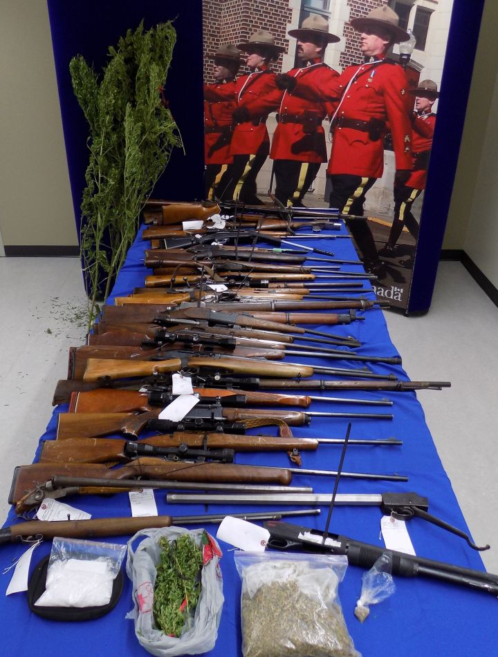 RCMP display dozens of stolen guns seized from a home east of Edmonton on Dec. 2, 2015.