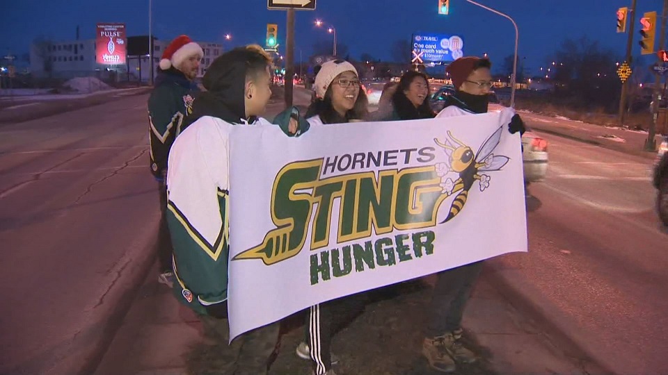 Students gather outside Tech-Voc high school Tuesday morning, collecting donations to fill a school bus. 