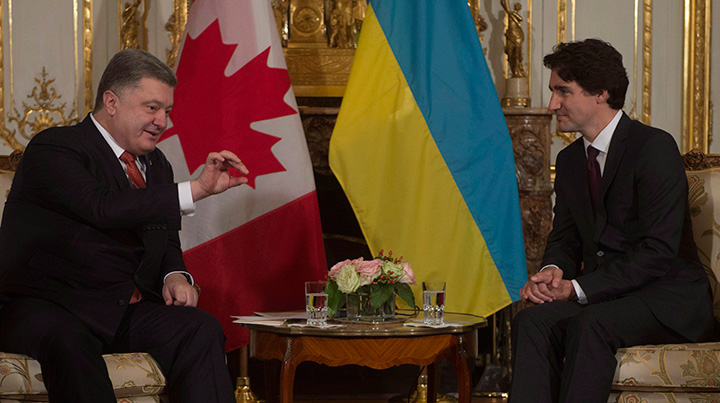 Prime Minister Justin Trudeau listens to Ukraine President Petro Poroshenko as they speak at the start of a bilateral meeting before the United Nations climate change summit in Paris, France, on Sunday, Nov. 29, 2015. 
