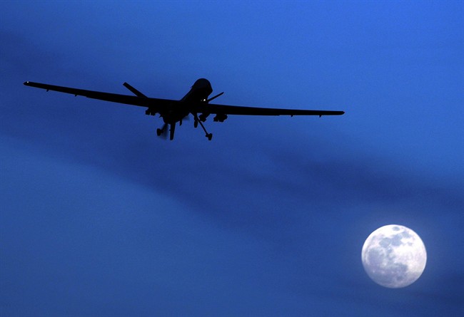 FILE - In this Jan. 31, 2010 file photo, an unmanned U.S. Predator drone flies over Kandahar Air Field, southern Afghanistan, on a moon-lit night.  (AP Photo/Kirsty Wigglesworth, File).
