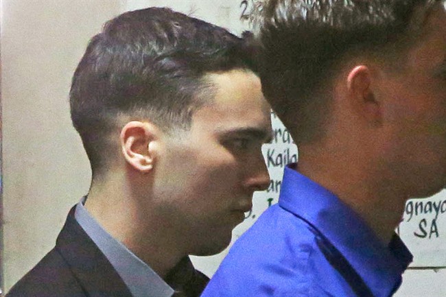 U.S. Marine Lance Cpl. Joseph Scott Pemberton, left, arrives for the verdict of his court case for the killing of Filipino transgender Jennifer Laude, at Olongapo city, Zambales province, northwest of Manila, Philippines on Tuesday Dec. 1, 2015. A Philippine court on Tuesday convicted Pemberton of killing a Filipino last year in a hotel after he discovered she was a transgender woman. (AP Photo/Aaron Favila).