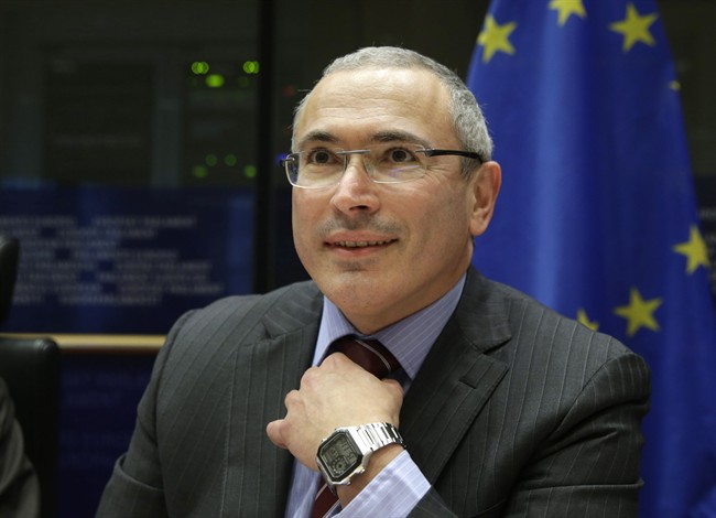 FILE - In this Dec. 2, 2014, file photo, Russian businessman and Amnesty International prisoner of conscience Mikhail Khodorkovsky smiles as he attends the Foreign Affairs Committee for a debate on human rights situation in Russia at the European Parliament building, in Brussels, Belgium. Russia's former richest man Khodorkovsky, who spent 10 years in prison before he was pardoned and left Russia in 2013, says he has been summoned for questioning in Moscow on Tuesday, Dec. 8, 2015. (AP Photo/Yves Logghe, File).