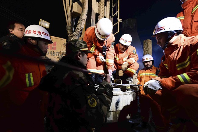In this Dec. 28, 2015 photo provided by China's Xinhua News Agency, rescuers try to contact the trapped people at a collapsed mine in Pingyi County, east China's Shandong Province. Chinese state media said rescuers have found eight surviving miners who have been trapped for five days by a collapse at a gypsum mine in eastern China. (Guo Xulei/Xinhua News Agency vi AP) NO SALES.