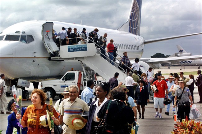 In this Nov. 1, 2001, file photo, the first passengers of the first flight of Continental Airlines from Miami Florida, arrives at the Jose Marti Airport of Havana, Cuba.