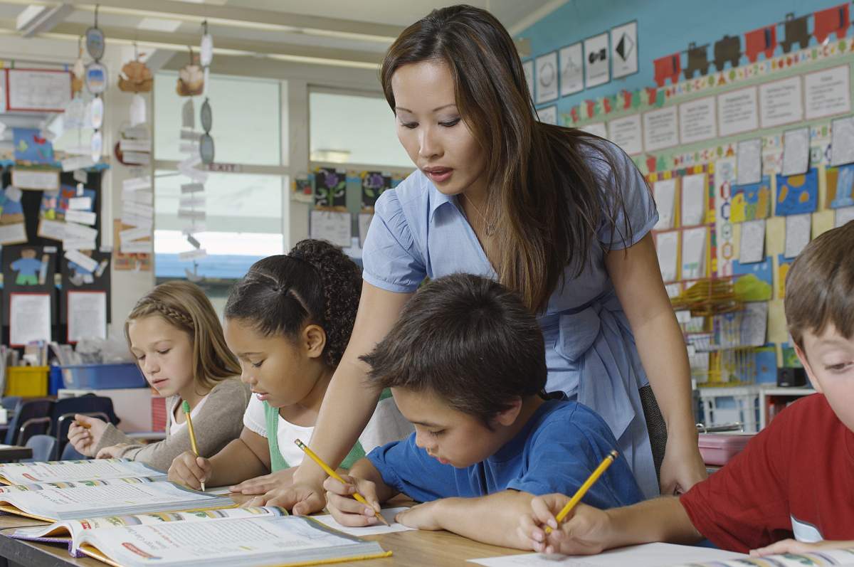 A file photo of a teacher and her pupils in classroom.