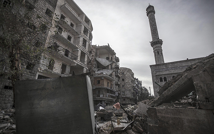 A mosque minaret still stands amid rubble from damaged buildings after an aircraft strike hit the mosque one week ago in Deir el-Zour.
