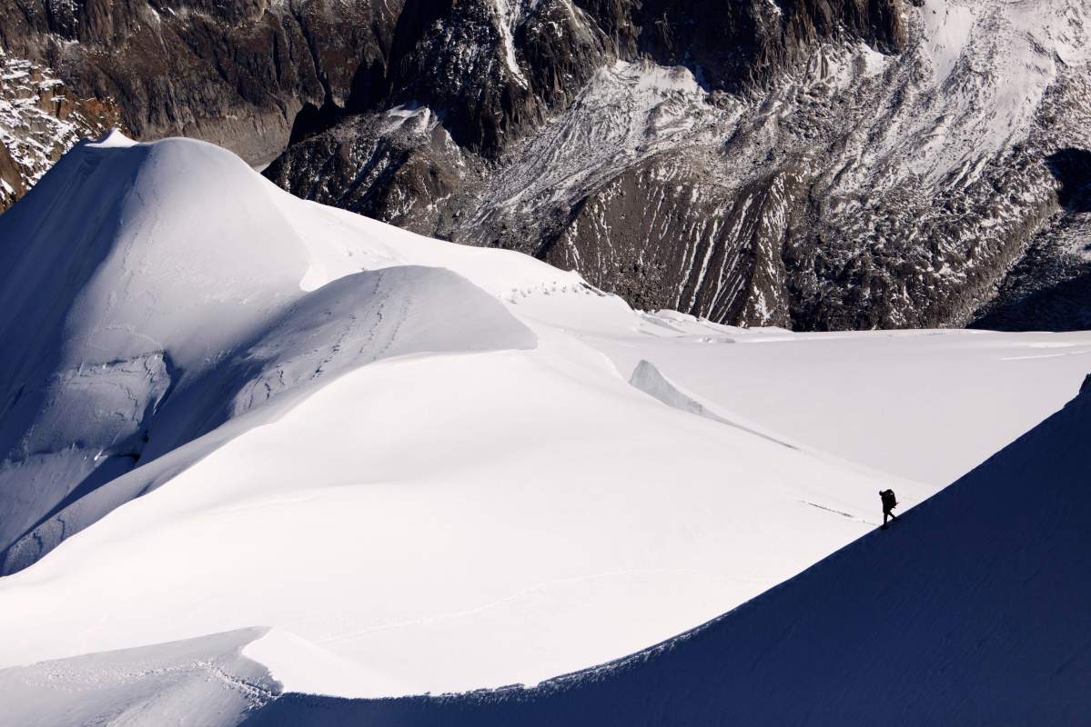 This Wednesday, Oct. 12, 2011 picture shows an alpinist heading down a ridge on the Aiguille du Midi towards the Vallee Blanche on the Mont Blanc massif, in the Alps, near Chamonix, France. 