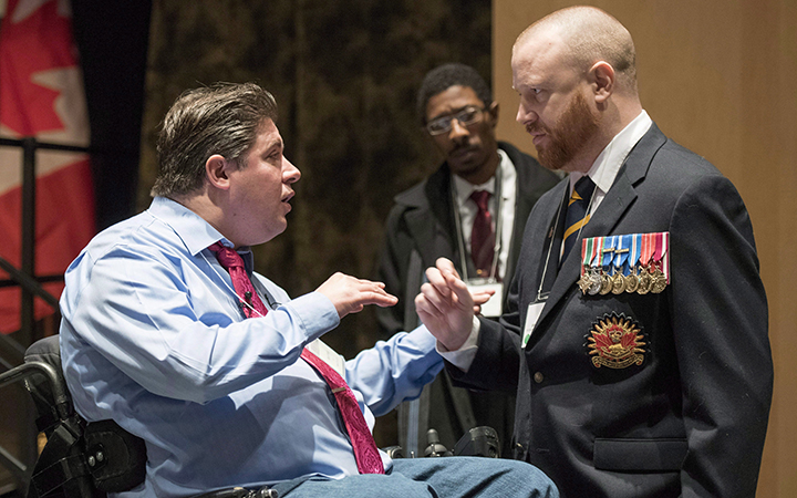 Minister of Veterans Affairs Kent Hehr speaks with veteran Brian McKenna, representing the 39 Brigade Group Wellbeing Network, at a stakeholder summit at the Canadian War Museum in Ottawa. 