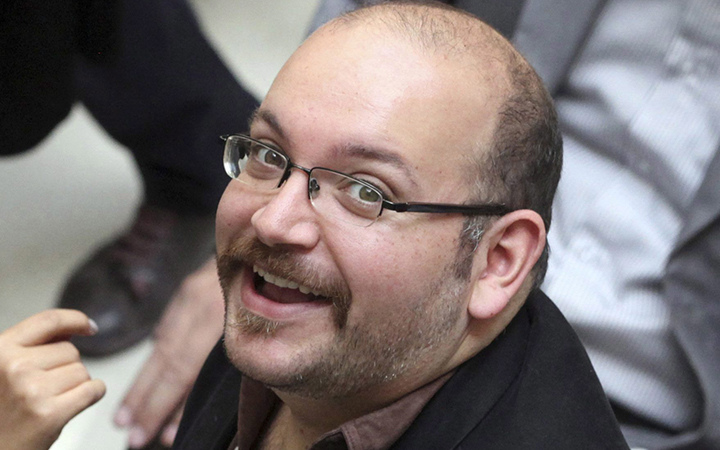 Jason Rezaian, an Iranian-American correspondent for the Washington Post, smiles as he attends a presidential campaign of President Hassan Rouhani in Tehran, Iran. 