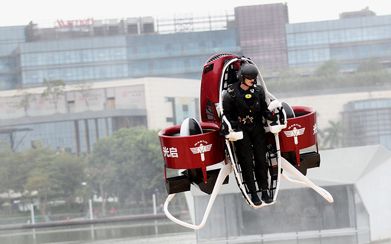 Director of Flight Operations from New Zealand-based Martin Aircraft Company, flies on a Martin Jetpack over a water park on December 6, 2015 in Shenzhen, China. 