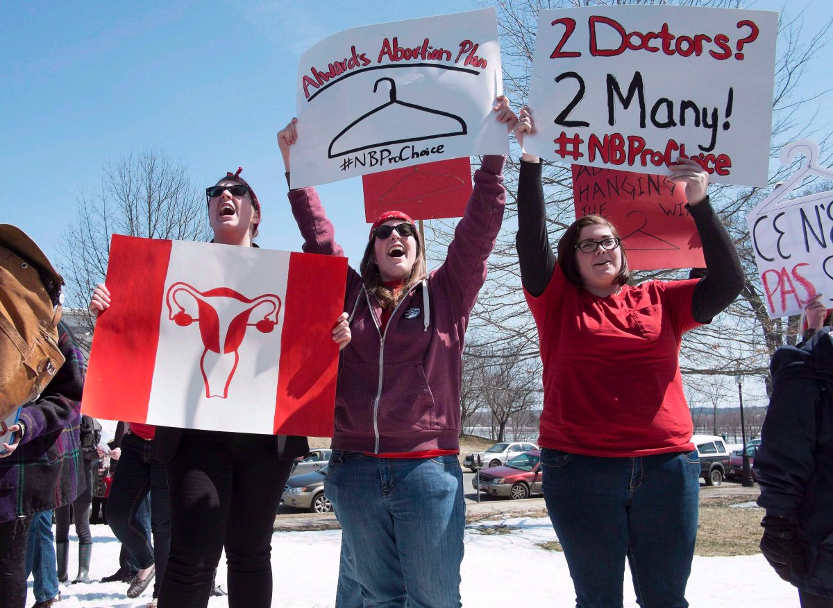 Women take part in a protest as pro-choice demonstrators rally at the New Brunswick legislature in Fredericton on Thursday, April 17, 2014. Barriers to abortion are creating stress and financial strain for Prince Edward Island women according to advocates. THE CANADIAN PRESS/David Smith.