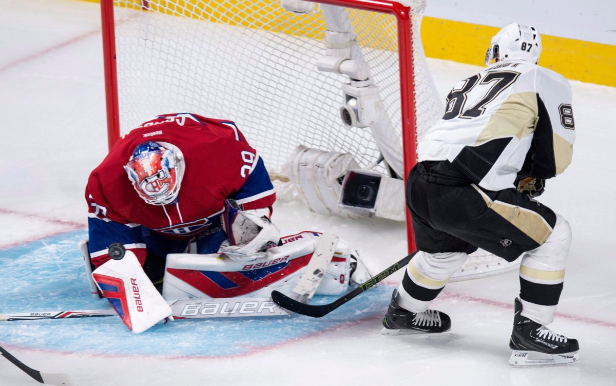 Montreal Canadiens goalie Mike Condon makes a save off Pittsburgh Penguins' Sidney Crosby during first period NHL hockey action Saturday, January 9, 2016 in Montreal.