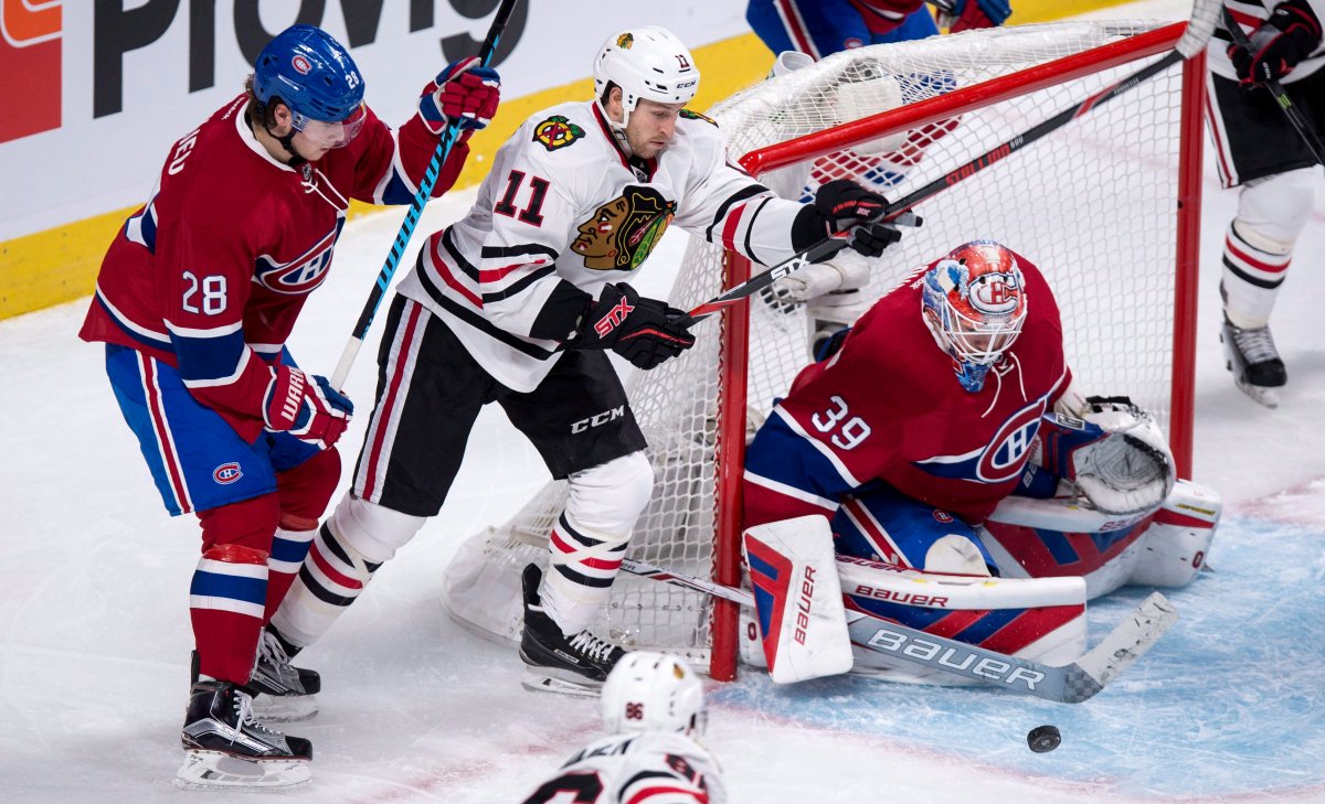Chicago Blackhawks' Andrew Desjardins tries to get to a loose puck in front of Montreal Canadiens goalie Mike Condon as he is covered by defenseman Nathan Beaulieu during second period NHL hockey action Thursday, January 14, 2016 in Montreal. 