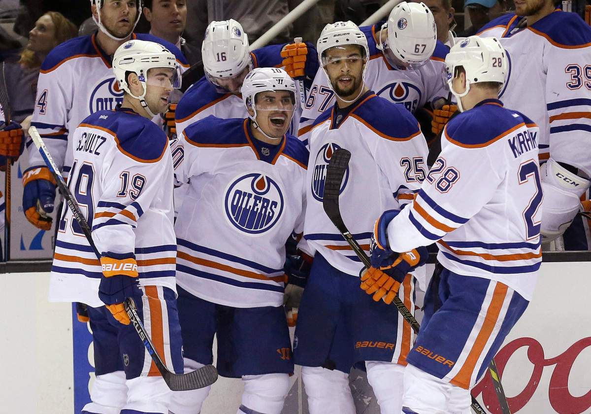 Edmonton Oilers right wing Nail Yakupov, second from left, celebrates after scoring against the San Jose Sharks, with defenseman Justin Schultz (19), defenseman Darnell Nurse (25) and left wing Lauri Korpikoski (28), from Finland, during the second period of an NHL hockey game in San Jose, Calif., Thursday, Jan. 14, 2016.