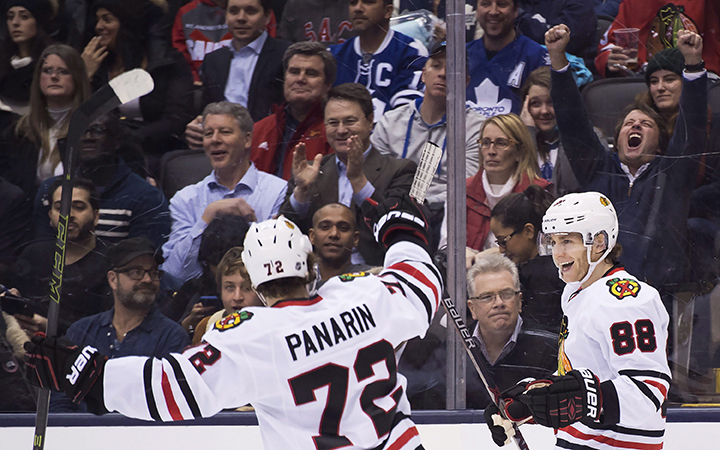 Chicago Blackhawks right wing Patrick Kane celebrates his hat trick against the Toronto Maple Leafs with teammate Artemi Panarin during third period NHL hockey action in Toronto on Friday, January 15, 2016. 
