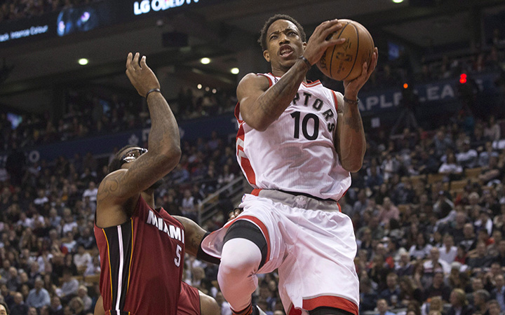 Toronto Raptors' DeMar DeRozan scores on Miami Heat's Amar'e Stoudemire during first half NBA basketball action in Toronto on Friday January 22, 2016. 