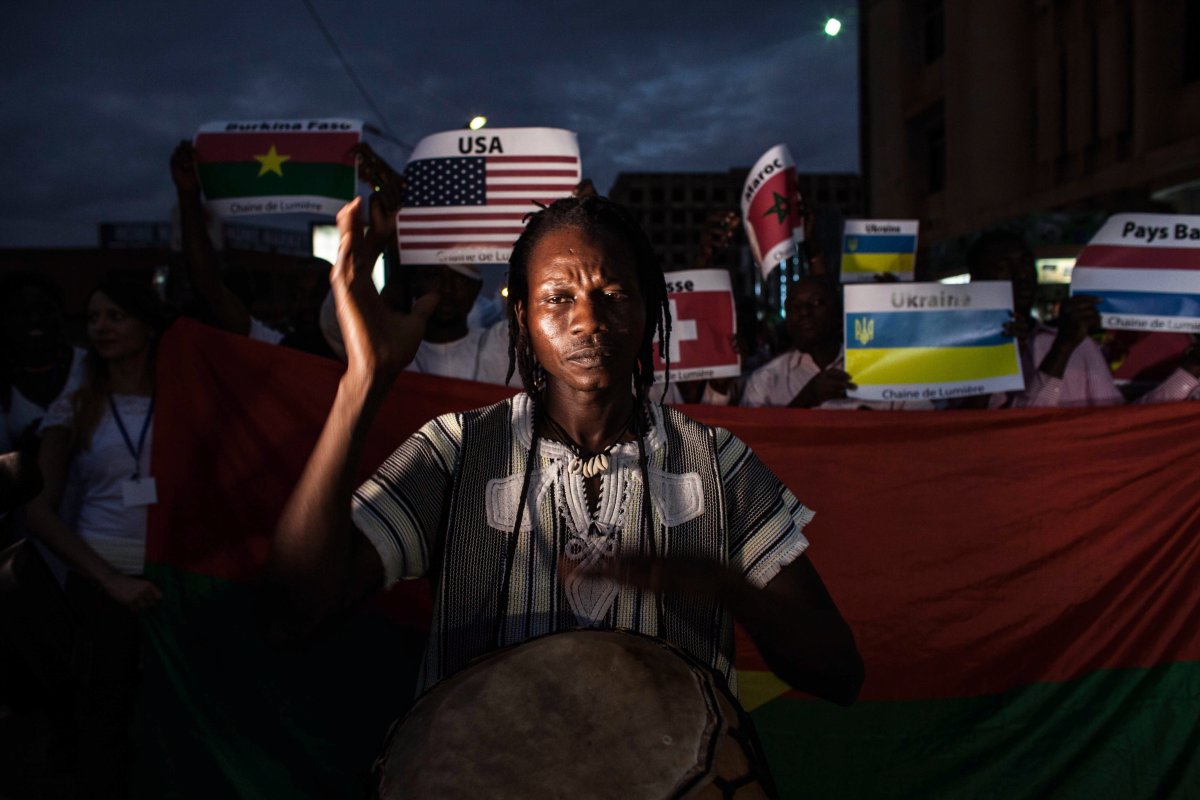 A man plays a traditional drum during the memorial ceremony for the victims of the recent hotel attack where extremist killed foreigners and Burkina Faso nationals, in Ouagadougou,  Burkina Faso, Saturday,  Jan. 23, 2016. Burials have begun for the 10 Burkina Faso nationals killed in last week's attack on a cafe and hotel in the capital, Ouagadougou, highlighting the local toll suffered in the latest West African country targeted by Islamic extremists. 