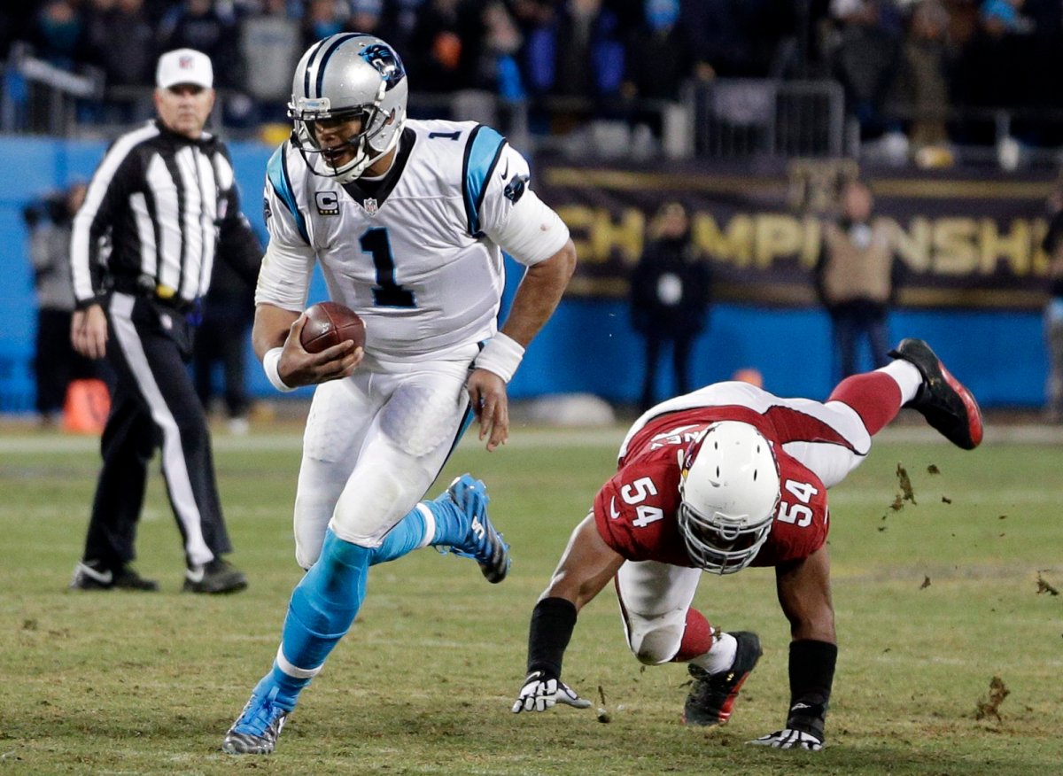 Carolina Panthers' Cam Newton runs past Arizona Cardinals' Kenny Demens for a first down during the second half the NFL football NFC Championship game Sunday, Jan. 24, 2016, in Charlotte, N.C.