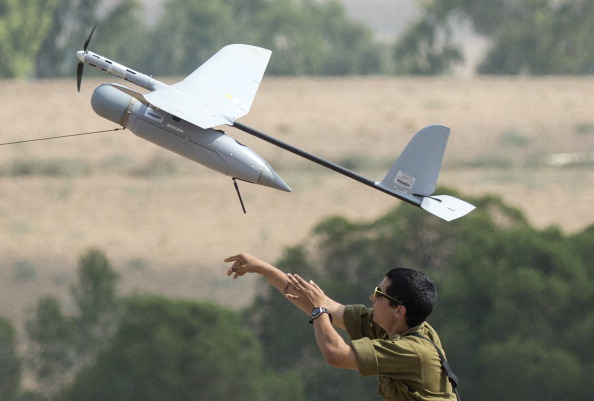 An Israel soldier launches an Israeli army's Skylark I unmanned drone aircraft, which is used for monitoring purposes, at an army deployment area near Israel's border with the besieged Palestinian territory on July 23, 2014. 