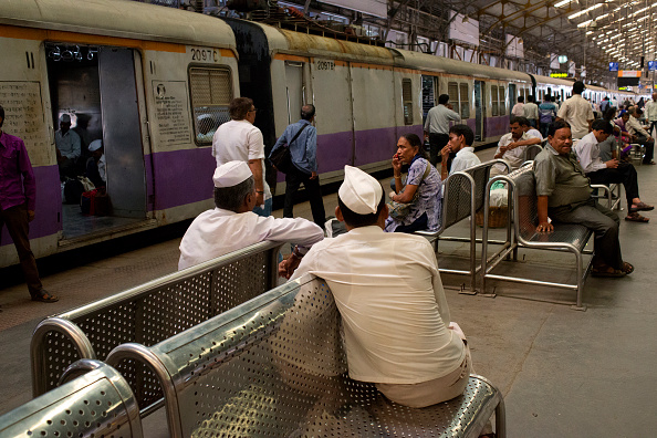 People wait on a platform  at Churchgate Railway Station in Mumbai. (Photo by Subhendu Sarkar/LightRocket via Getty Images).
