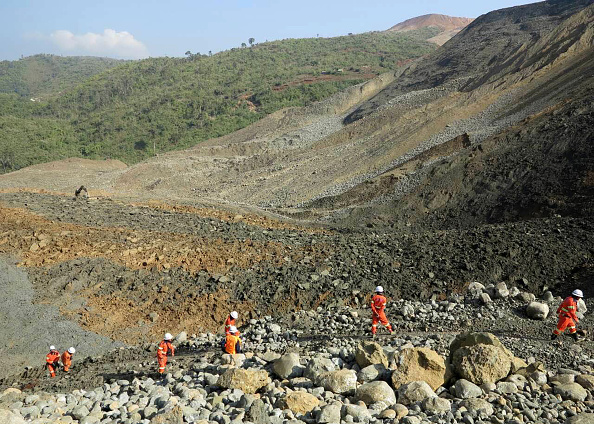 Rescue workers are pictured at the site of a landslide on December 26, 2015 in Hpakant, Kachin State, the war-torn area that is the epicentre of Myanmar's secretive billion dollar jade industry. 