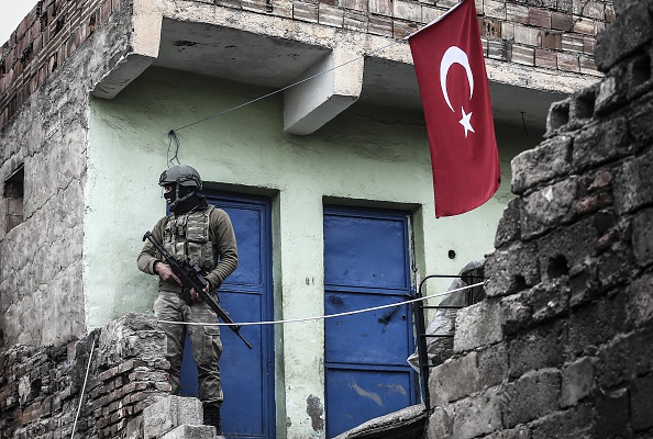 A soldier stands guard at a neighborhood as Turkish Security Forces carry out a counter - terrorism operation against terrorist organization PKK in Turkey's south-eastern province Diyarbakir's Sur District on January 21, 2016. (Photo by Stringer/Anadolu Agency/Getty Images).