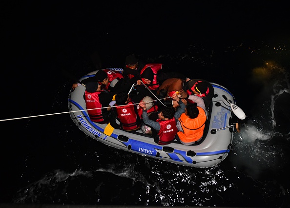 Turkish Coast Guard members intervene a boat carrying refugees, who were trying to go to Greek Islands, after being caught by the Turkish coast guards near the coast of Bodrum district in Mugla, Turkey on January 20, 2016.