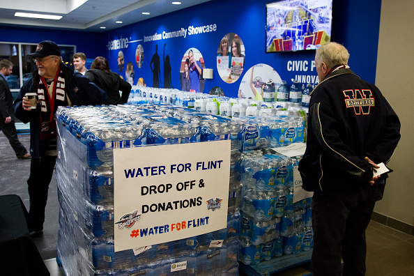 Fans bring in donations of bottled water prior to the game between the Flint Firebirds and the Windsor Spitfireson January 21, 2016 at the WFCU Centre in Windsor, Ontario, Canada. The Windsor Spitfires organization requested that fans bring in a donation of bottled water to help with the Flint Michigan water crisis. (Photo by Dennis Pajot/Getty Images).