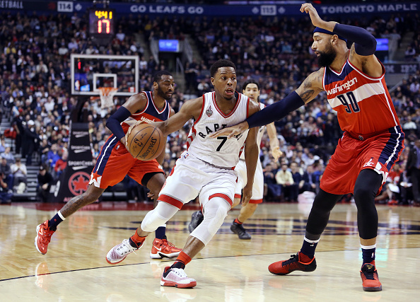 Kyle Lowry #7 of  the Toronto Raptors dribbles the ball as Drew Gooden #90 of the Washington Wizards defends during an NBA game at the Air Canada Centre on January 26, 2015 in Toronto, Ontario, Canada.  (Photo by Vaughn Ridley/Getty Images).